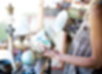 woman holding vase and lid in thrift store